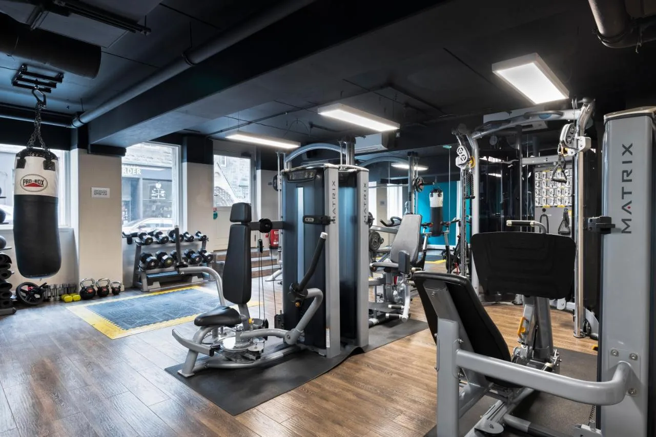 a gym with treadmills and weights at Radisson Blu Hotel, Edinburgh City Centre in Edinburgh