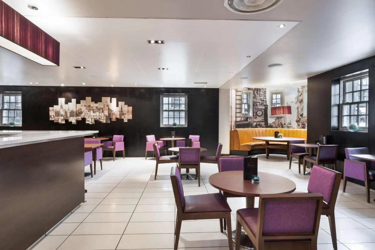 a dining room with purple chairs and tables at Radisson Blu Hotel, Edinburgh City Centre in Edinburgh